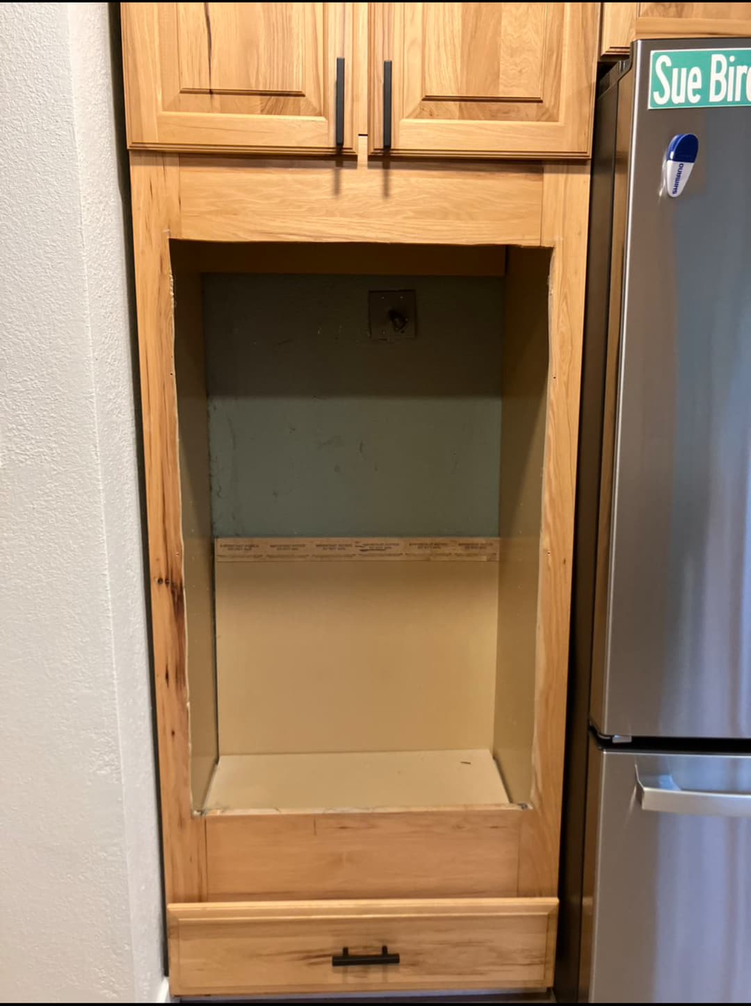 Built-in storage cabinet installation with open shelving